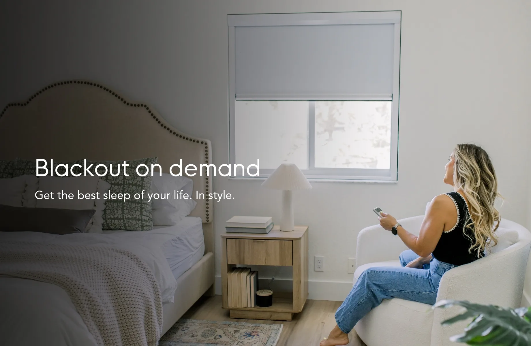 Blackout on demand — get the best sleep of your life, in style. Shown in a bedroom with the shade lowered by remote