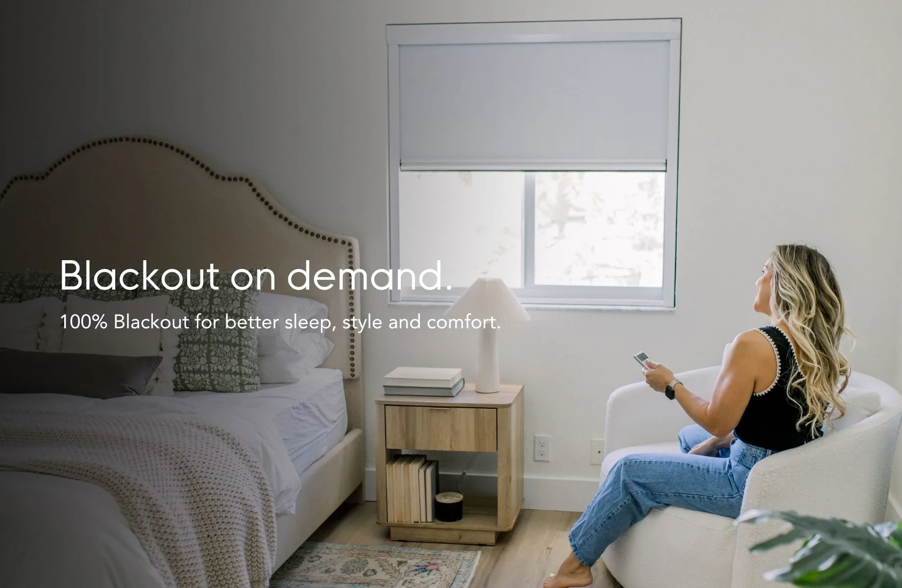 Blackout on demand — 100% blackout for better sleep, style and comfort, shown in a bedroom with the shade lowered by remote