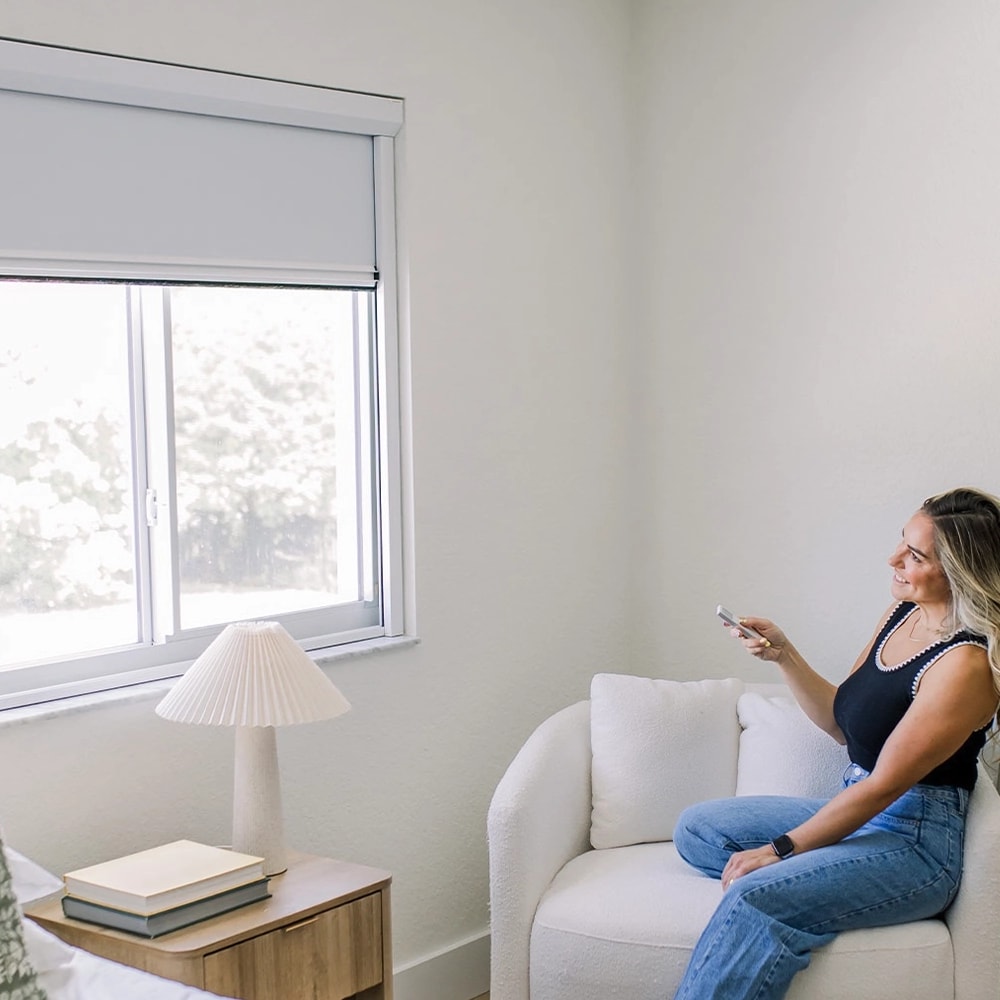 A bedroom with the shade lowered, controlled from the sofa