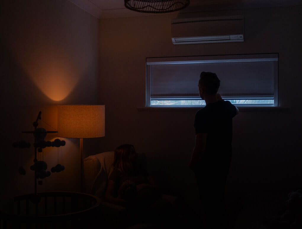 Living room at night with the shade down and a lamp lit